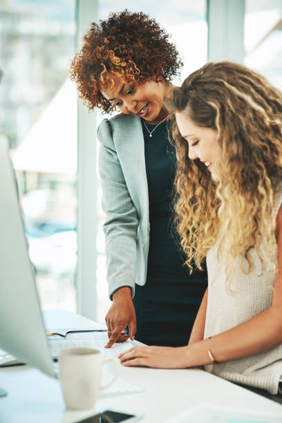 Shot of two businesswomen working together in an office